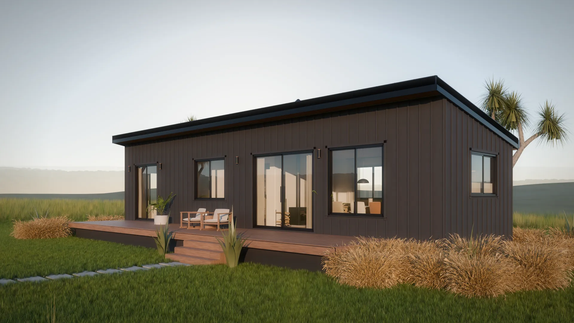 A long black house under a single roof rising toward its deck, red tussock and lawn in low evening sun.