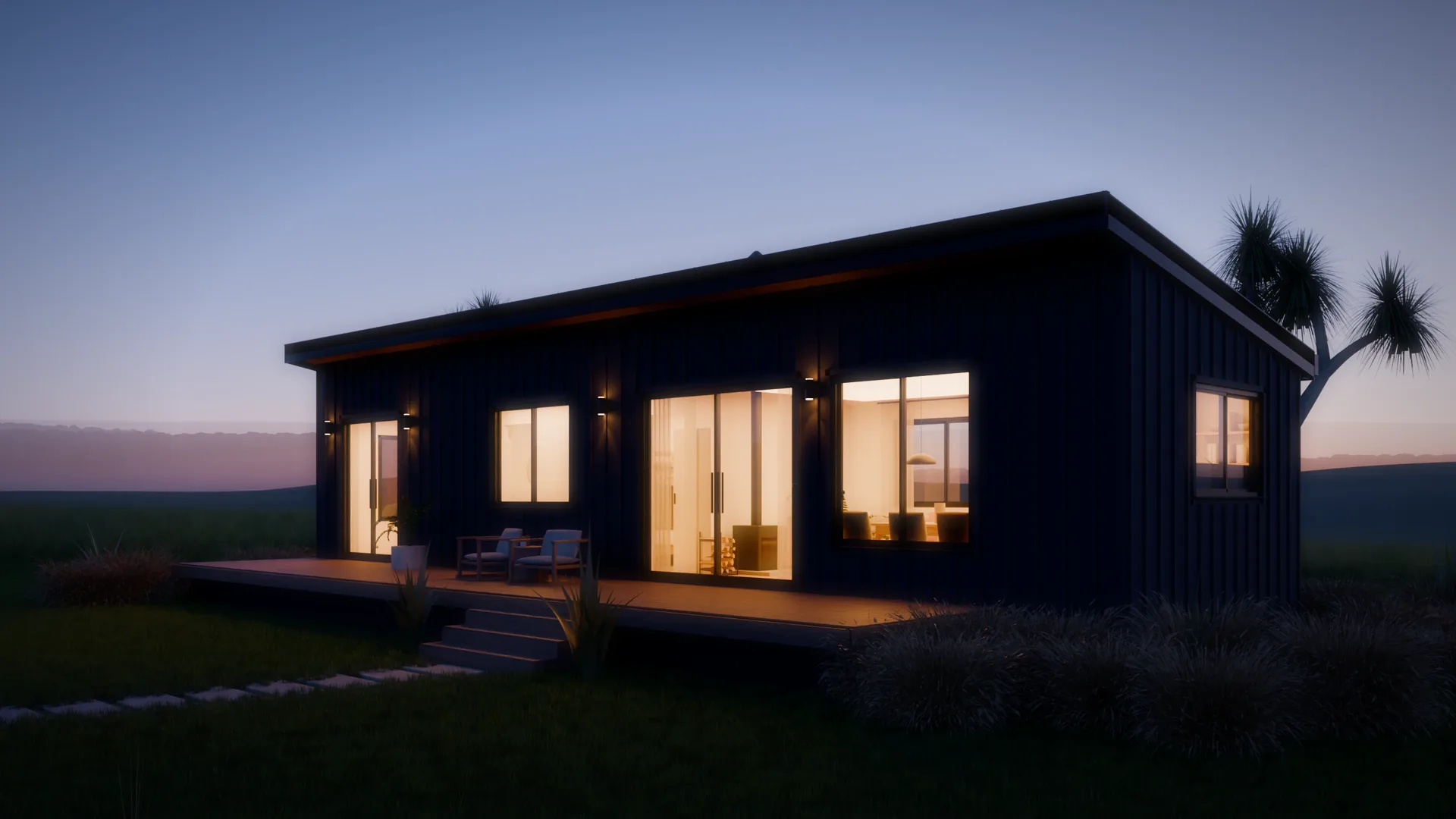 Kahu at night: every window lit warm, wall lights on the black cladding, a deep blue sky.